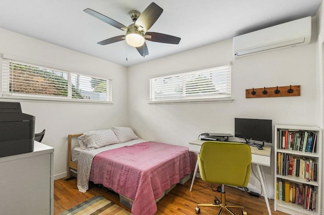 6053 Mohler St, San Diego, CA 92120 - bedroom with a wall mounted air conditioner, wood finished floors, a desk, and ceiling fan