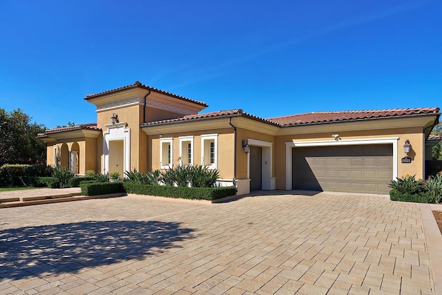 15527 Artesian Ridge Rd, San Diego, CA 92127 - mediterranean / spanish house with stucco siding, a garage, decorative driveway, and a tiled roof