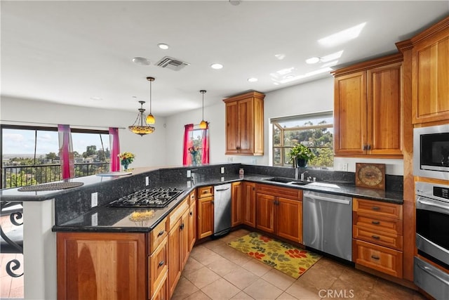 633 Sunnyhill Dr, Los Angeles, CA 90065 - kitchen featuring stainless steel appliances, a peninsula, a warming drawer, a sink, and light tile patterned floors