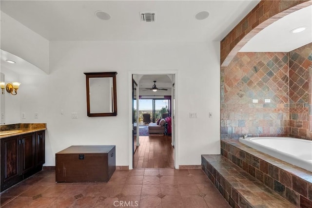 633 Sunnyhill Dr, Los Angeles, CA 90065 - bathroom featuring ensuite bath, a bath, vanity, baseboards, and a ceiling fan