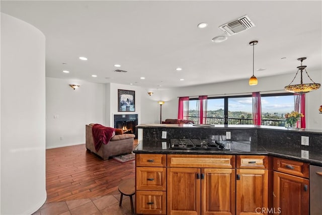 633 Sunnyhill Dr, Los Angeles, CA 90065 - kitchen featuring black gas cooktop, recessed lighting, open floor plan, pendant lighting, and a warm lit fireplace