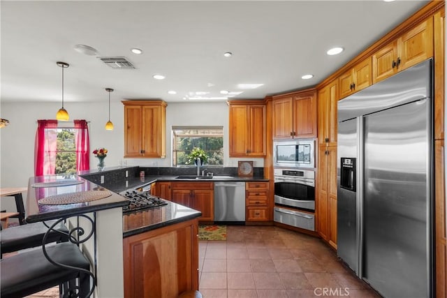 633 Sunnyhill Dr, Los Angeles, CA 90065 - kitchen with built in appliances, a peninsula, healthy amount of natural light, a sink, and recessed lighting
