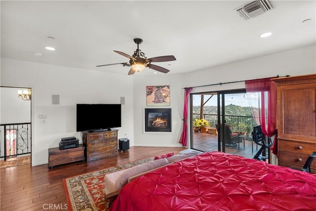 633 Sunnyhill Dr, Los Angeles, CA 90065 - bedroom featuring access to outside, hardwood / wood-style floors, a glass covered fireplace, recessed lighting, and ceiling fan