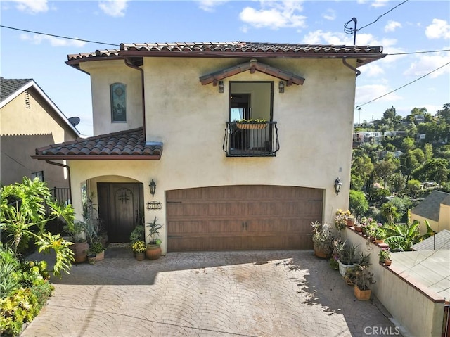 633 Sunnyhill Dr, Los Angeles, CA 90065 - mediterranean / spanish-style home featuring a garage, a tile roof, stucco siding, and decorative driveway