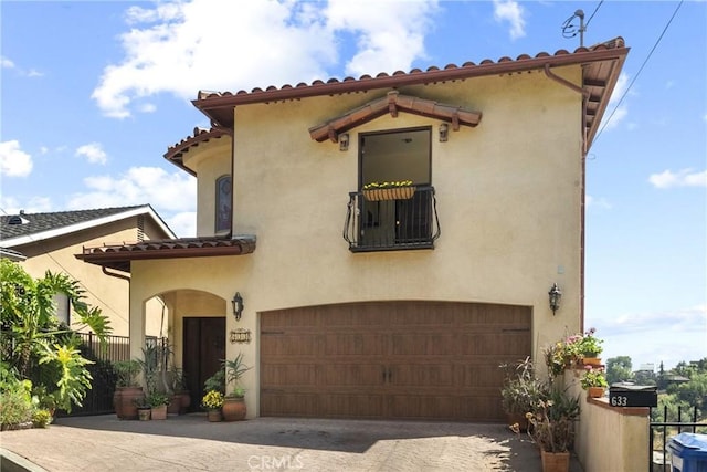633 Sunnyhill Dr, Los Angeles, CA 90065 - mediterranean / spanish-style house featuring an attached garage, stucco siding, and driveway