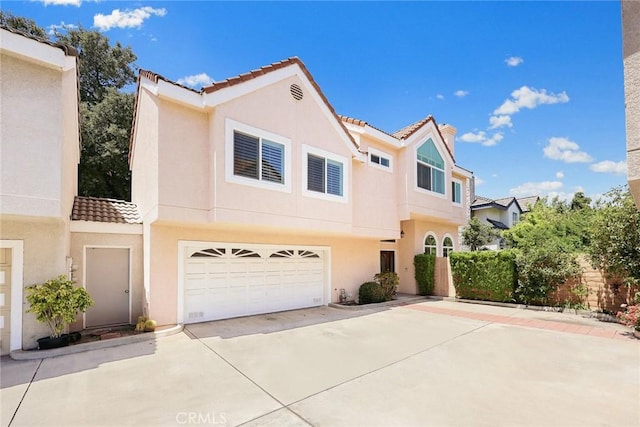 407 E Duarte Rd Unit D, Arcadia, CA 91006 - townhome / multi-family property featuring a tiled roof, concrete driveway, stucco siding, and a garage