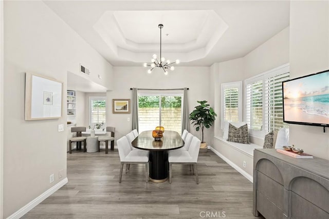 407 E Duarte Rd Unit D, Arcadia, CA 91006 - dining space with a chandelier, wood finished floors, baseboards, and a raised ceiling