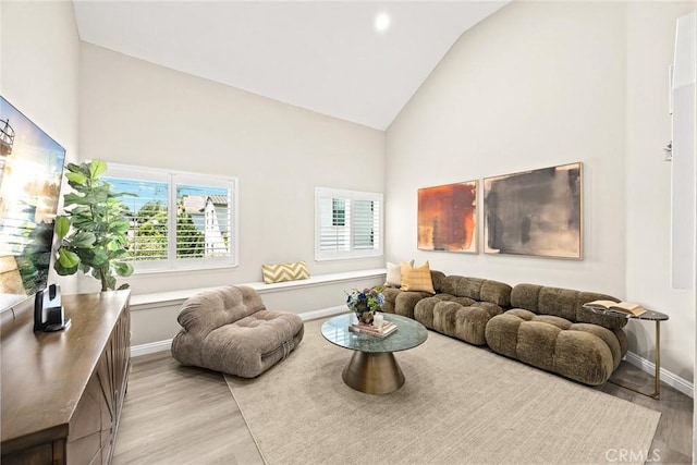 407 E Duarte Rd Unit D, Arcadia, CA 91006 - living room featuring high vaulted ceiling, light wood finished floors, plenty of natural light, and baseboards