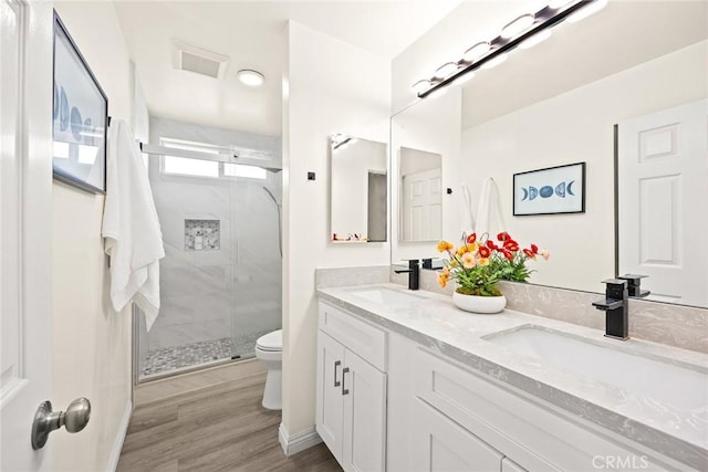 407 E Duarte Rd Unit D, Arcadia, CA 91006 - full bathroom featuring double vanity, toilet, a stall shower, and wood finished floors