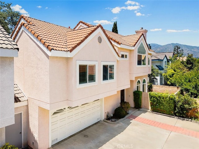 407 E Duarte Rd Unit D, Arcadia, CA 91006 - view of front of home featuring stucco siding, a garage, and a mountain view
