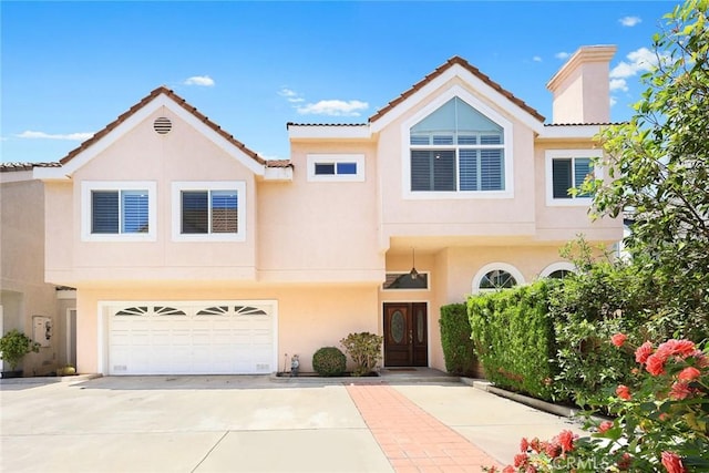 407 E Duarte Rd Unit D, Arcadia, CA 91006 - townhome / multi-family property with driveway, stucco siding, an attached garage, and a chimney