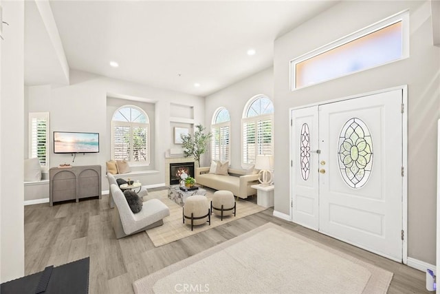 407 E Duarte Rd Unit D, Arcadia, CA 91006 - entryway with healthy amount of natural light, wood finished floors, baseboards, recessed lighting, and a glass covered fireplace