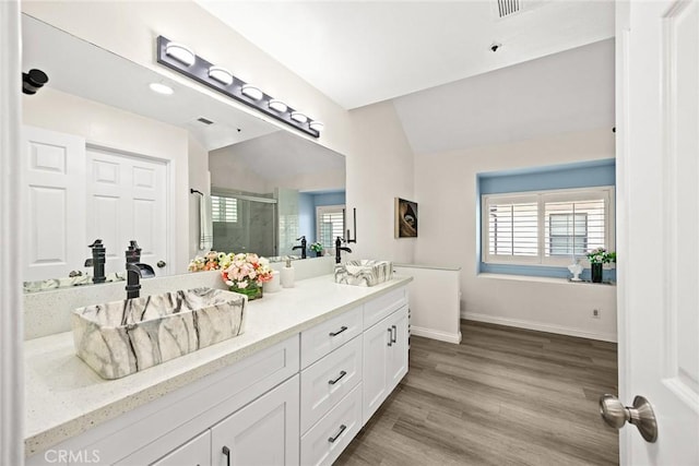 407 E Duarte Rd Unit D, Arcadia, CA 91006 - bathroom with double vanity, a stall shower, vaulted ceiling, wood finished floors, and baseboards