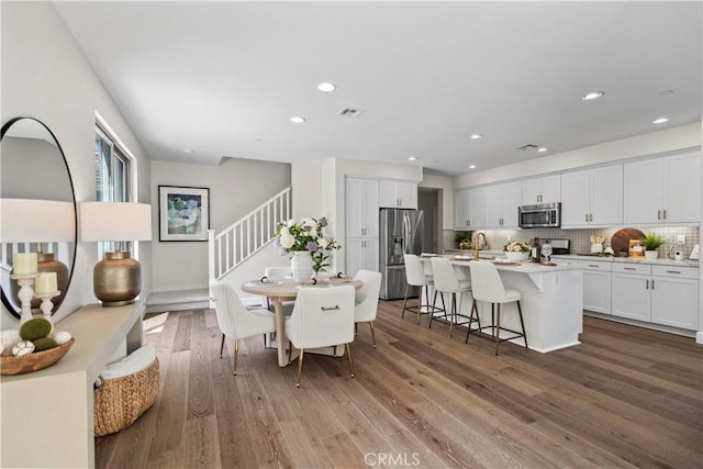 166 Borrego, Irvine, CA 92618 - dining area featuring stairs, wood finished floors, and recessed lighting