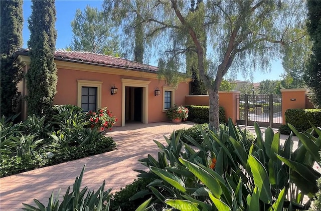 166 Borrego, Irvine, CA 92618 - view of front of home with stucco siding and a tile roof