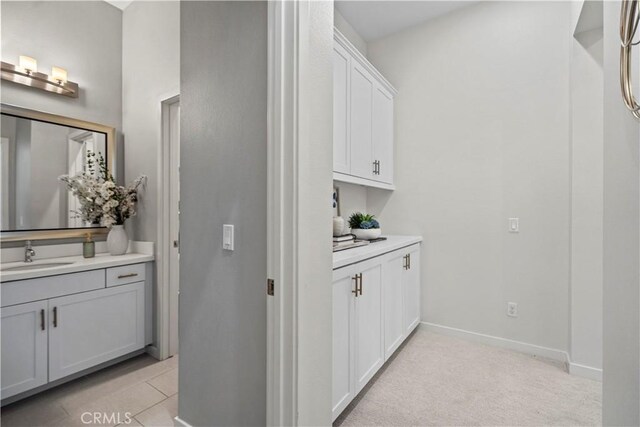 166 Borrego, Irvine, CA 92618 - bar area featuring a sink, baseboards, and light colored carpet
