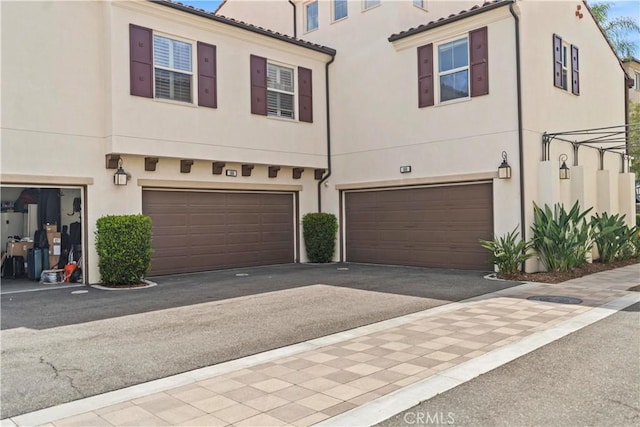 166 Borrego, Irvine, CA 92618 - townhome / multi-family property with an attached garage, stucco siding, driveway, and a tiled roof