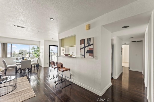 1436 257th St Unit 303, Harbor City, CA 90710 - dining area with a textured ceiling, baseboards, and dark wood-style floors