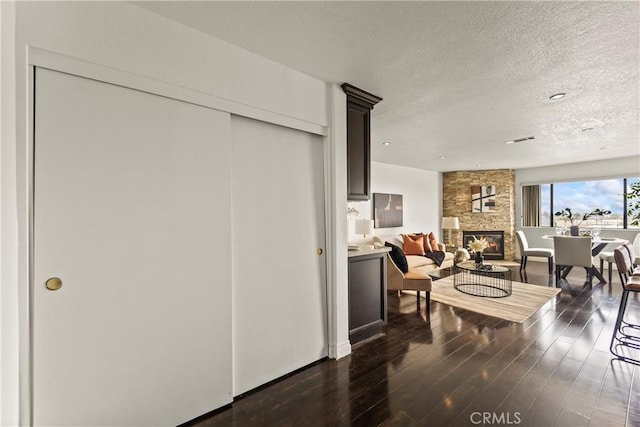 1436 257th St Unit 303, Harbor City, CA 90710 - dining room featuring a fireplace, a textured ceiling, dark wood-type flooring, and recessed lighting