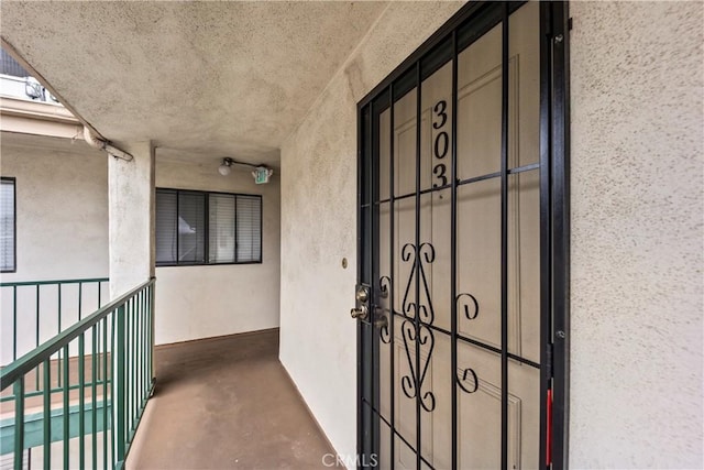 1436 257th St Unit 303, Harbor City, CA 90710 - view of exterior entry featuring stucco siding and a balcony