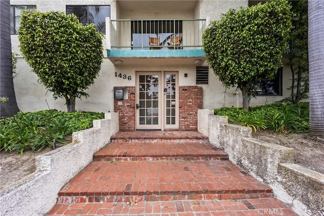 1436 257th St Unit 303, Harbor City, CA 90710 - property entrance featuring a balcony, stucco siding, and french doors