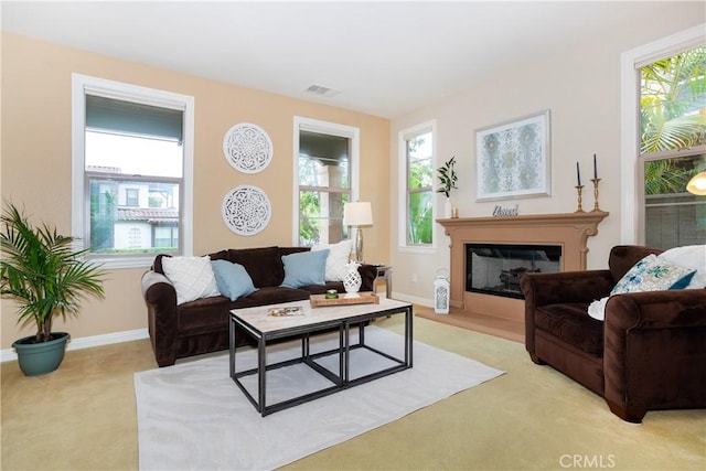 15530 New Park Ter, San Diego, CA 92127 - living room featuring light carpet, plenty of natural light, a glass covered fireplace, and baseboards