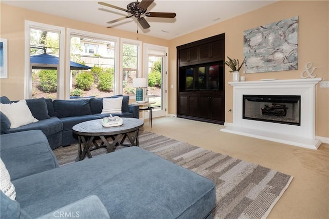 15530 New Park Ter, San Diego, CA 92127 - carpeted living area featuring a glass covered fireplace, ceiling fan, and baseboards