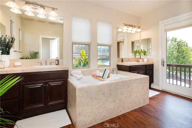 15530 New Park Ter, San Diego, CA 92127 - bathroom featuring two vanities, a bath, and wood finished floors