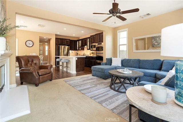 15530 New Park Ter, San Diego, CA 92127 - carpeted living area with ceiling fan, a sink, and recessed lighting