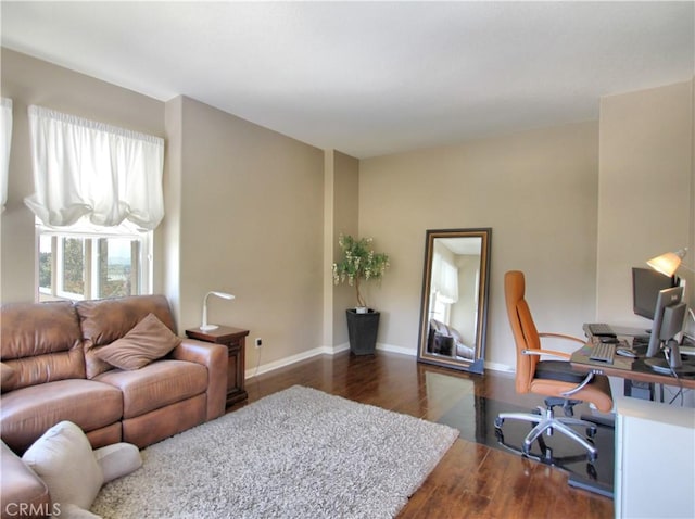 12949 Pinewood Ln, Yucaipa, CA 92399 - living area with wood finished floors, a desk, and baseboards