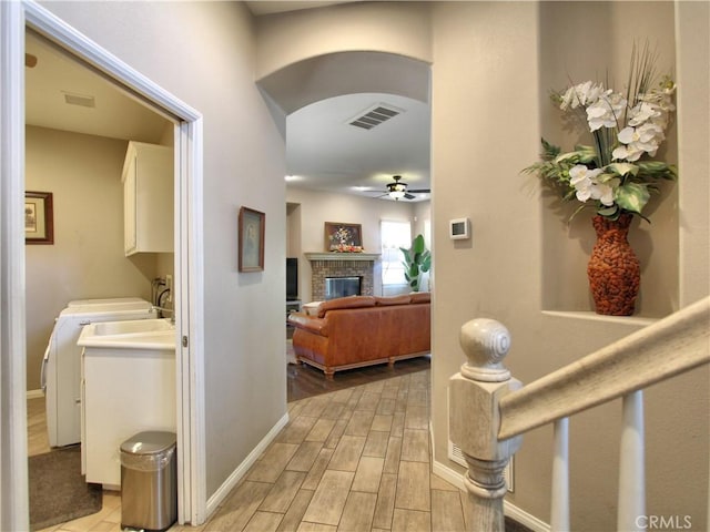 12949 Pinewood Ln, Yucaipa, CA 92399 - hall featuring separate washer and dryer, light wood-type flooring, and baseboards