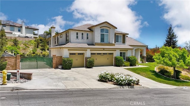 12949 Pinewood Ln, Yucaipa, CA 92399 - view of front of house featuring an attached garage, driveway, stucco siding, a gate, and a tile roof