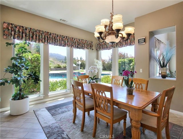 12949 Pinewood Ln, Yucaipa, CA 92399 - dining space with a chandelier, light tile patterned floors, and baseboards