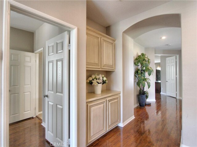 12949 Pinewood Ln, Yucaipa, CA 92399 - hall with arched walkways, baseboards, dark wood-type flooring, and recessed lighting