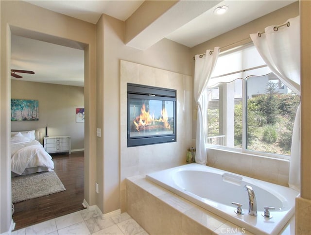 12949 Pinewood Ln, Yucaipa, CA 92399 - bathroom featuring a bath, ensuite bath, a ceiling fan, baseboards, and marble finish flooring