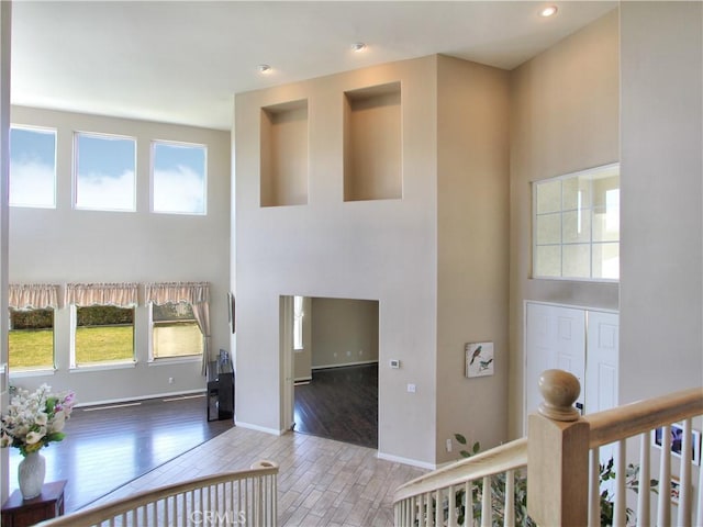 12949 Pinewood Ln, Yucaipa, CA 92399 - foyer with a high ceiling, healthy amount of natural light, wood finished floors, recessed lighting, and baseboards