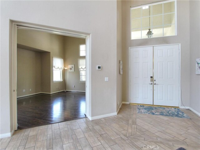 12949 Pinewood Ln, Yucaipa, CA 92399 - foyer with wood finished floors, baseboards, and a high ceiling