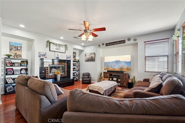 6688 Banyan Ave, Hesperia, CA 92345 - living room with dark wood-type flooring, a ceiling fan, a fireplace, and recessed lighting