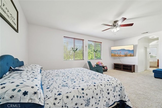 6688 Banyan Ave, Hesperia, CA 92345 - bedroom with arched walkways, carpet flooring, ceiling fan, and ensuite bath