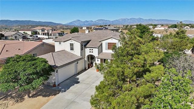 6688 Banyan Ave, Hesperia, CA 92345 - traditional home with driveway, a residential view, a mountain view, and stucco siding
