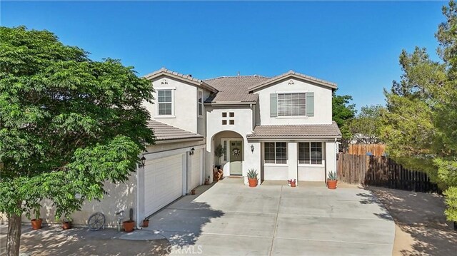 6688 Banyan Ave, Hesperia, CA 92345 - traditional-style home featuring driveway, a tiled roof, stucco siding, and an attached garage