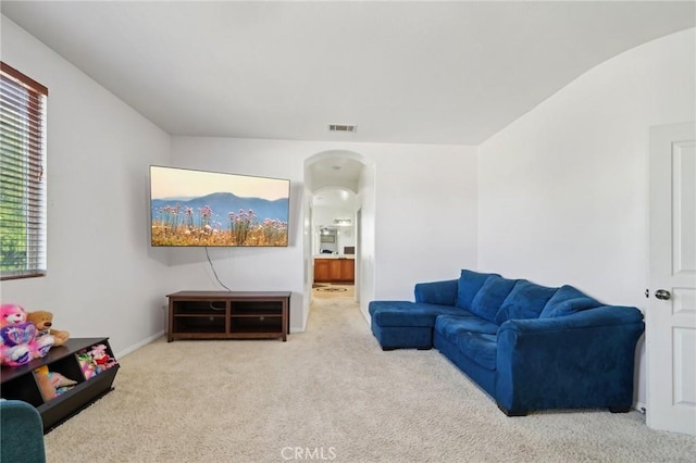 6688 Banyan Ave, Hesperia, CA 92345 - living room featuring arched walkways and carpet floors