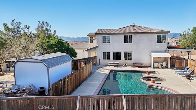 6688 Banyan Ave, Hesperia, CA 92345 - view of swimming pool featuring a fenced backyard, a mountain view, a patio, and a pool with connected hot tub