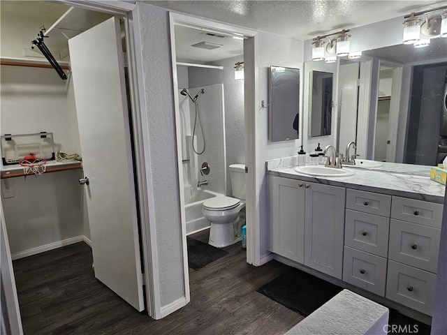 3532 W Stonepine Ln Unit B, Anaheim, CA 92804 - full bath featuring wood finished floors, vanity, a walk in closet, toilet, and a textured ceiling