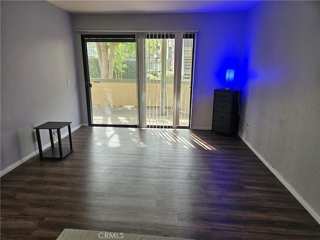 3532 W Stonepine Ln Unit B, Anaheim, CA 92804 - empty room with dark wood-style flooring, baseboards, and a textured wall