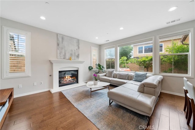 323 La Ventana Dr, Brea, CA 92823 - living area with plenty of natural light, a glass covered fireplace, wood finished floors, baseboards, and recessed lighting