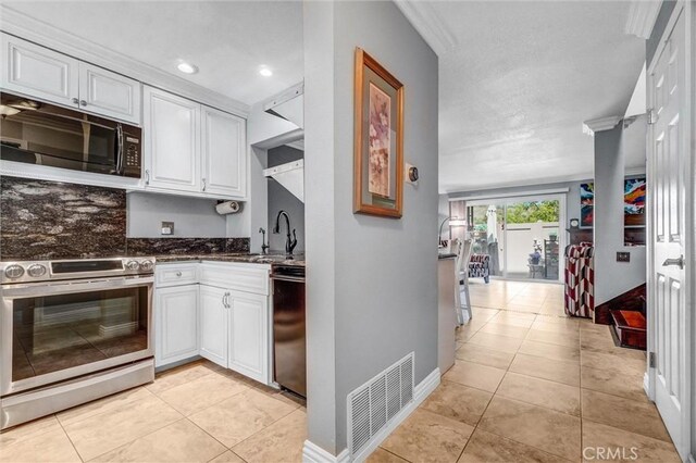 5927 E Creekside Ave Unit 18, Orange, CA 92869 - kitchen with black appliances, a sink, light tile patterned flooring, white cabinetry, and recessed lighting