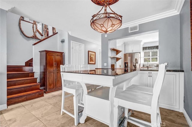 5927 E Creekside Ave Unit 18, Orange, CA 92869 - dining space with crown molding, stairs, baseboards, and light tile patterned flooring