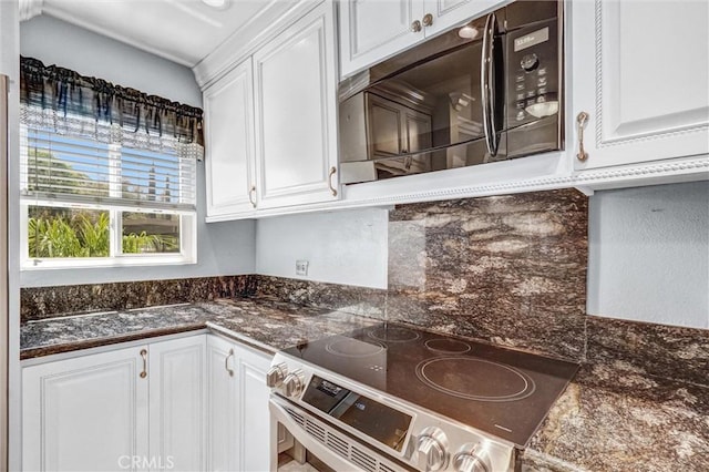 5927 E Creekside Ave Unit 18, Orange, CA 92869 - kitchen featuring stainless steel electric stove, black microwave, white cabinets, and decorative backsplash