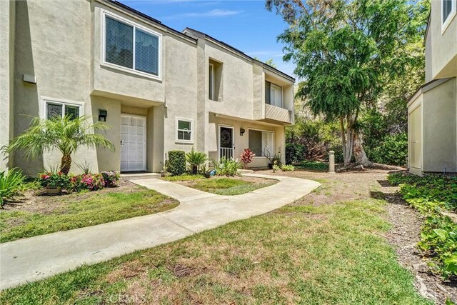 5927 E Creekside Ave Unit 18, Orange, CA 92869 - view of front facade featuring stucco siding and a front yard